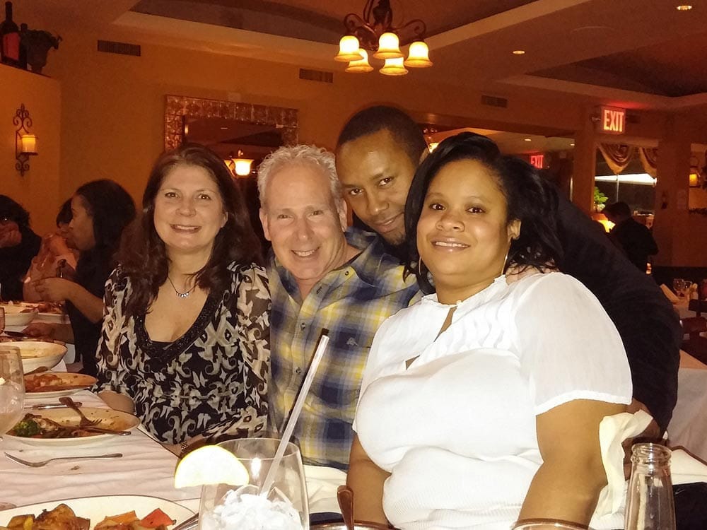 Staff smiling at table