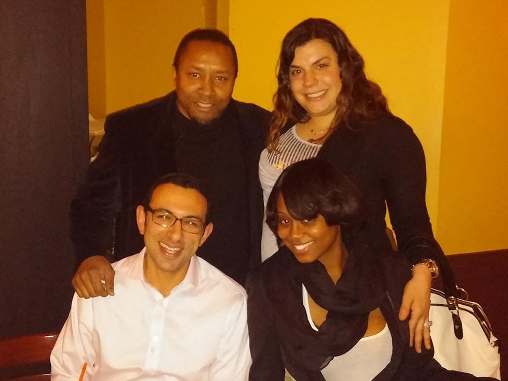 Staff smiling at table