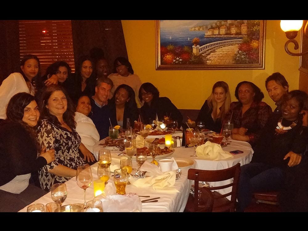 Staff smiling at table